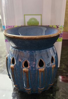 a blue vase sitting on top of a table