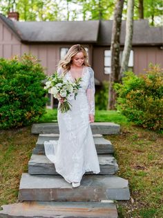 a woman in a wedding dress walking down some steps