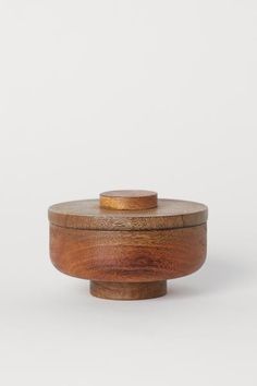 a small wooden box with a lid on the top and bottom, sitting against a white background