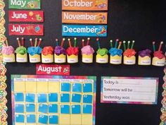 a bulletin board is decorated with cupcakes and calendars