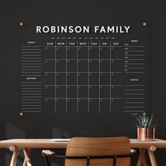 a blackboard with the words robinson family written on it next to a wooden table