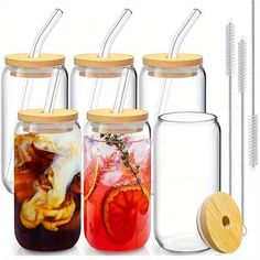 four jars with different types of drinks in them