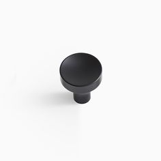 a black knob on a white background