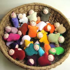 a basket filled with small stuffed animals sitting on top of a table