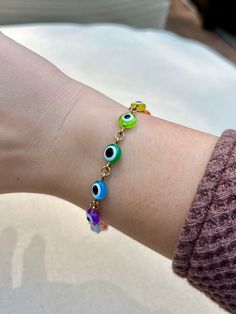 Multicolor rainbow evil eye gold chain link bracelet! Minimalist boho jewelry style. Select size from the dropdown menu. Hand-crafted with love and care. ~ More Evil Eye Bracelets ~ White Freshwater Pearl: https://shopcrystalelements.etsy.com/listing/1659617834 Multicolor Heishi Bead Stretch: https://shopcrystalelements.etsy.com/listing/1678043091 Red Seed Bead Stretch: https://shopcrystalelements.etsy.com/listing/1641157566 Silver Stretch: https://shopcrystalelements.etsy.com/listing/1719950613 Trendy Adjustable Multicolor Chain Bracelet, Trendy Multicolor Adjustable Chain Bracelet, Trendy Multicolor Evil Eye Jewelry, Multicolor Metal Everyday Jewelry, Multicolor Evil Eye Jewelry, Multicolor Everyday Metal Jewelry, Everyday Multicolor Metal Jewelry, Trendy Multicolor Evil Eye Bracelet With Colorful Beads, Dainty Multicolor Bracelets With Adjustable Chain