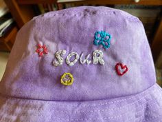 Hand embroidered and tie-dyed bucket hat! One size fits most. 58cm. MADE TO ORDER: Hat will not look EXACTLY like the image as each hat is made after purchase. Casual Spring Bucket Hat With Embroidered Logo, Casual Embroidered Adjustable Bucket Hat, Casual Purple Cotton Bucket Hat, Spring Wide Brim Bucket Hat With Embroidered Logo, Casual Embroidered Festival Hats, Casual Purple Bucket Hat For Spring, Casual Purple Bucket Hat With Curved Brim, Handmade Casual Bucket Hat, Summer Bucket Hat With Embroidered Logo