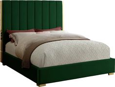 a bed with green headboard and pillows on it