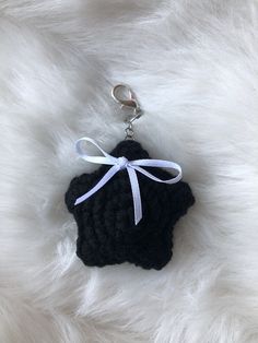 a keychain with a black and white crochet piece tied to it