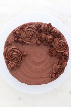 a chocolate frosted cake with flowers on top