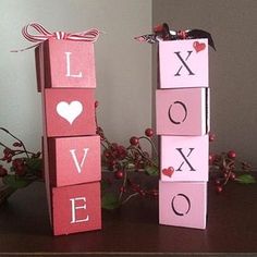 two valentine's day blocks sitting on top of a table