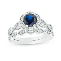 Ask for her hand and her heart with this gorgeous bridal set. Crafted in cool 10K white gold, this beautiful style showcases a 6.0mm lab-created bright blue sapphire wrapped in a floral frame adorned with sparkling diamonds and intricate milgrain detailing. The shank lends heirloom appeal with sculpted marquise shapes shimmering with petite diamonds and milgrain detailing. On your wedding, complete her look with the coordinating wedding band that features glistening diamonds in milgrain-lined ma Fine Jewelry Diamond Bridal Sets With Accent Stones, Silver Bridal Sets With Diamond And Accent Stones, 14k White Gold Wedding Jewelry With Accent Stones, Sapphire Wedding Ring With Diamond Accents, Diamond Bridal Sets With Accent Stones For Wedding, Anniversary Bridal Sets In White Gold, Blue 14k White Gold Wedding Ring, Hand-set Sterling Silver Bridal Sets For Anniversary, White Sapphire Wedding Set