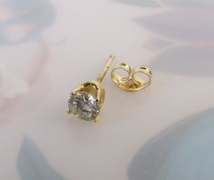 "This listing is for 1 (SINGLE) Vintage diamond 14k yellow gold stud post earring. It is perfect for the person who wears only one earring on one side or has multiple piercings on their ear or ears. A certified gemologist verbally verified the diamond as genuine and graded it with an SI2 (si2) clarity and I-J color. The 3.70mm round brilliant-cut gem has an approximate weight of .20 carat. It has a nice sparkle to it and four sturdy prongs hold it tightly in the 14k yellow gold crown style setti 14k Yellow Gold Solitaire Earrings, Gold Solitaire Diamond Earrings Fine Jewelry, Gold Solitaire Diamond Earrings, Gold Solitaire Diamond Earrings For Anniversary, Gold Solitaire Round Earrings, Elegant Gold Solitaire Earrings, Diamond White Solitaire Diamond Earrings In 14k Gold, 14k Gold Solitaire Diamond White Diamond Earrings, Diamond White Solitaire Earrings In 14k Gold