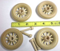 three wooden wheels and one measuring tape