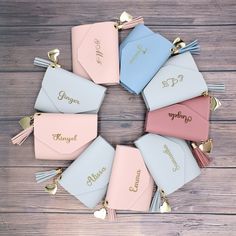 the personalized wallets are arranged in a circle with tassels on them