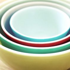 four colorful bowls stacked on top of each other