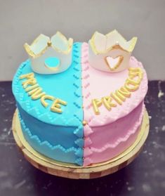 two cakes decorated with crowns on top of each other, one is blue and the other is pink