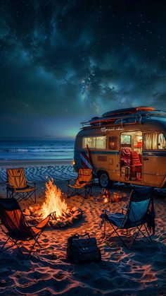 a camper van is parked on the beach with chairs around it at night time