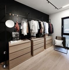 an empty room with clothes hanging on racks