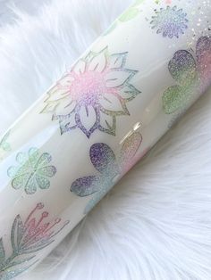 a close up shot of the inside of a white tube with glitter flowers on it