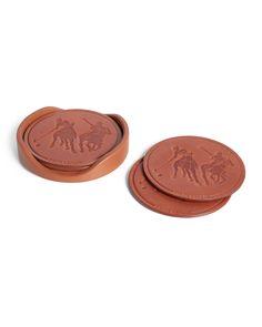 two brown coasters sitting on top of each other