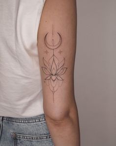 a woman's arm with a tattoo on it and a crescent in the middle