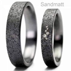 two wedding bands with diamonds on them are shown in white gold and black ceramic, one is