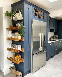 What a cute idea if your home does not have a lot of pantry space! Awkward Space Kitchen, Stove Next To Refrigerator Layout, Baskets On Side Of Cabinets, Small Florida Kitchen Ideas, Painted Kitchen Cabinets Apartment, Kitchen Cabinets On One Wall, Shelves Around Refrigerator, Cabinet Around Refrigerator Ideas, Small Drop Zone Ideas Kitchen