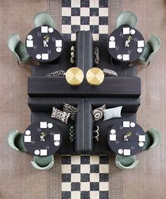 an overhead view of a black and white checkered floor with tables and chairs on it