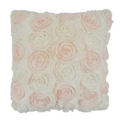 a white and pink pillow with roses on the front, sitting against a white background