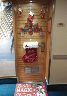 a door decorated with christmas decorations and stockings