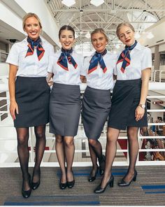 three flight attendants are posing for the camera