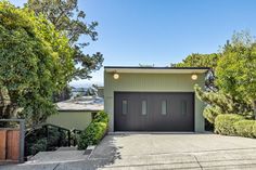 this is an image of a house in the suburbs with trees and bushes around it