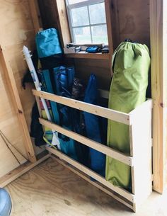 the inside of a small wooden cabin with various items in it and a bag on the floor