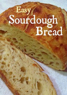 a loaf of sourdough bread sitting on top of a white towel with the words easy sourdough bread