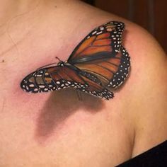 a close up of a person with a butterfly tattoo on their shoulder and chest,