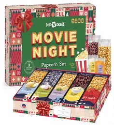 the popcorn box is filled with movie night snacks and popcorns, along with two boxes of popcorn