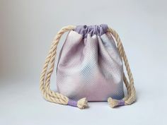 "Keep your things together with this handcrafted drawstring pouch.  With the square bottom it stands on its own so you have easy access. Ideal for all gaming pieces, tokens, dice, cosmetics or crafting materials.  - the bag is handmade out of 100% cotton fabric.  - lavender, pink and Blue pattern with a drawstring to close and open, lavender purple inside.  - the circumference of the bag is at 28cm/ 11\" up top and standing 11cm/ 4,3\" tall.  - with a square bottom of 8x6cm/ 3,1x2,3\"  - it opens an closes with a drawstring, which can be tied for storing and transport.  - machine washable at 30oC. *Dice are for scale, they are NOT included* Doesn't quite fit your vision? CUSTOM ORDERS are available! If you'd like to have your very own customized pouch, get in touch, so we can choose fabric Bag Of Holding, Lavender Pink, Dice Bag, Crafting Materials, Macrame Cord, Drawstring Pouch, Lavender Purple, Pouch Bag, Blue Pattern