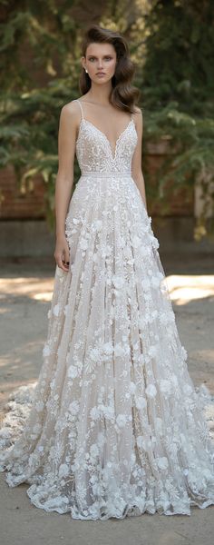 a woman in a wedding dress with flowers on it