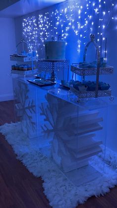 the dessert table is set up with frosted cake and cupcakes on it