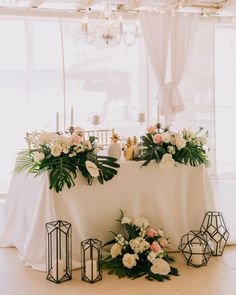 the table is set with flowers and candles