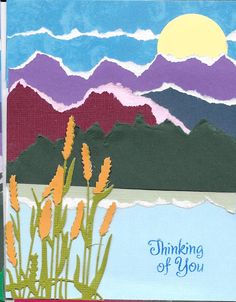 a card with the words thinking of you on it and some flowers in front of mountains