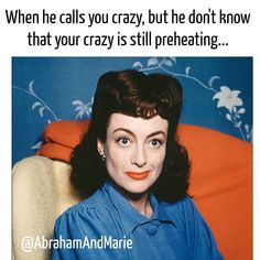 a woman sitting on top of an orange chair next to a blue wall with the words, when he calls you crazy, but he don't know that your crazy, that your crazy, is still preheating