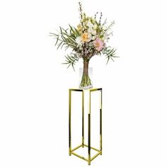 a vase filled with flowers sitting on top of a metal stand