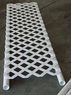 a white metal grate sitting on top of a cement floor