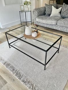 a living room with two couches and a coffee table on the rug in front of it