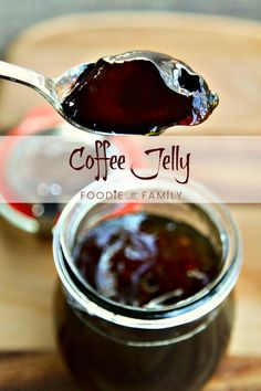 a spoon full of jam sitting on top of a wooden table