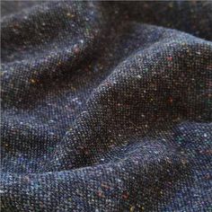 the fabric is very dark blue with multicolored speckles on it's surface