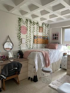 a bedroom with a bed, desk and chair in it next to a window that has ivy growing on the wall