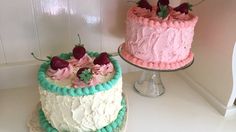 two cakes sitting on top of a white counter