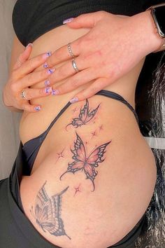 a woman's stomach with a butterfly tattoo on her belly and the bottom part of her abdomen